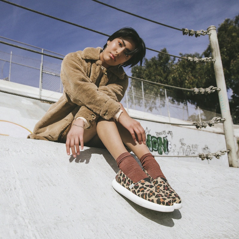 Model wearing Toms leopard shoes.